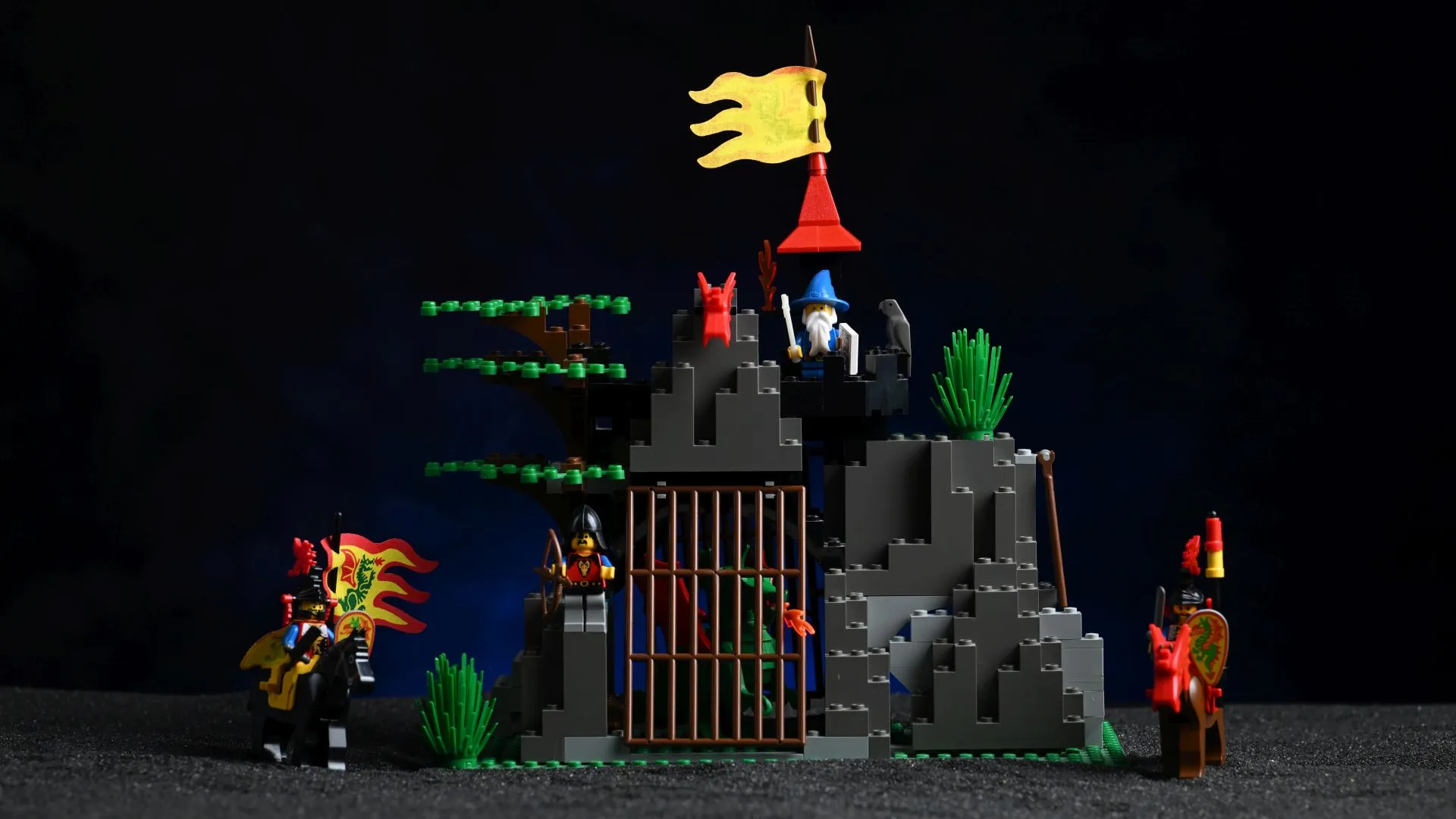 LEGO Castle Dark Dragon's Den (6076): 33 years and still holding together The complete LEGO Castle Dark Dragon's Den (6076) set from 1993, fully built after 33 years, with its rocky den, barred dragon cage, wizard's tower, and mounted Dragon Knights
