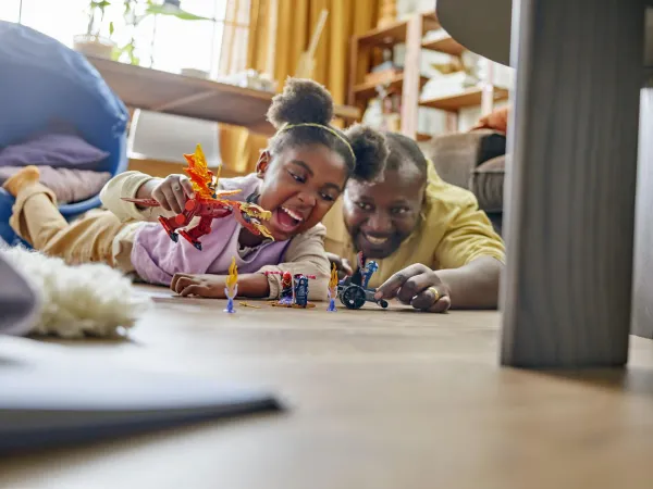 A parent and child building LEGO together - official LEGO lifestyle photo