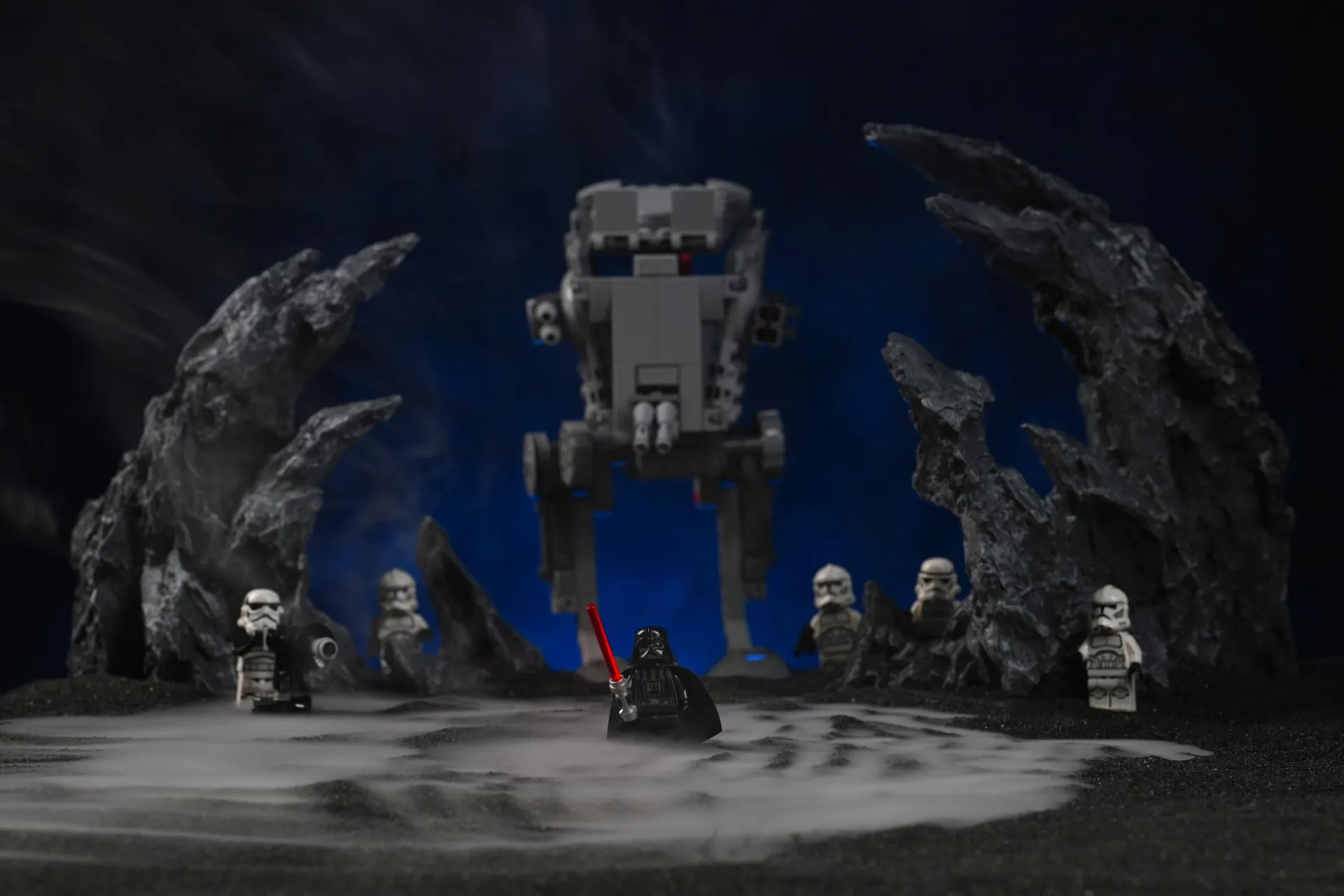 PMI SmokeNINJA: The Fog Machine Behind Our Toy Photography A LEGO Darth Vader minifigure standing in front of an AT-ST walker and a squad of clone troopers, with thick dry-ice-style fog pooling across the black ground and rising between dark rock formations